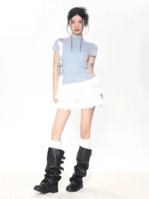 Light blue women’s slim fit mock neck short sleeve baby tee styled with a white ruffle mini skirt and knee-high boots