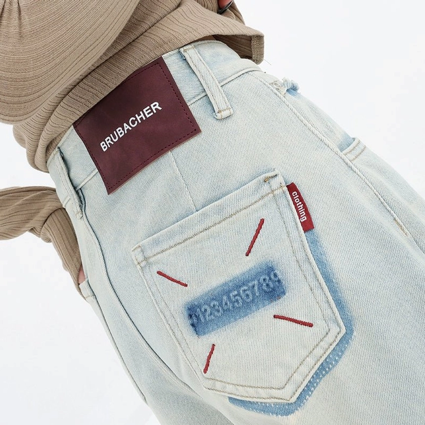 Light blue women’s wide-leg jeans with a relaxed high-rise fit, faded finish, and embroidered back-pocket detail