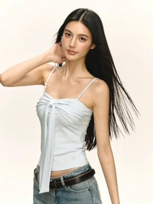 Light blue Y2K ruched bow front camisole top with pearl beaded spaghetti straps styled with high waisted jeans and black leather belt