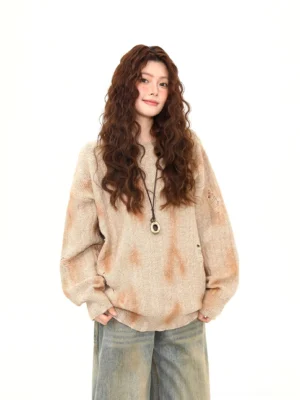 Light brown distressed tie-dye oversized knit sweater front full-body view styled with vintage wide-leg denim