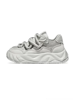 Light gray chunky platform sneakers shown in left side profile with breathable mesh panels, leather trims, rounded laces, and a sculpted wavy rubber outsole