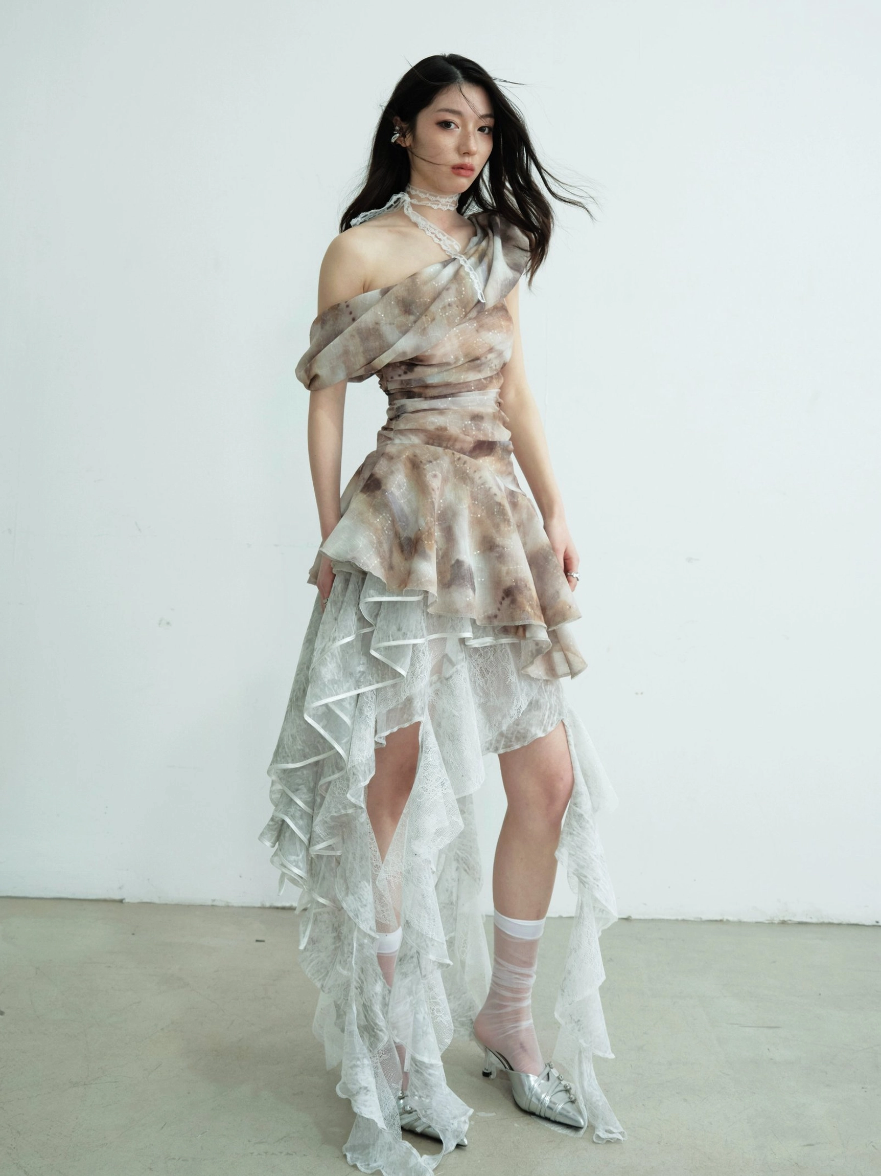 Asymmetric ruffle styling inspiration for a lace tube top maxi skirt with a high-low layered hem in a minimalist white studio