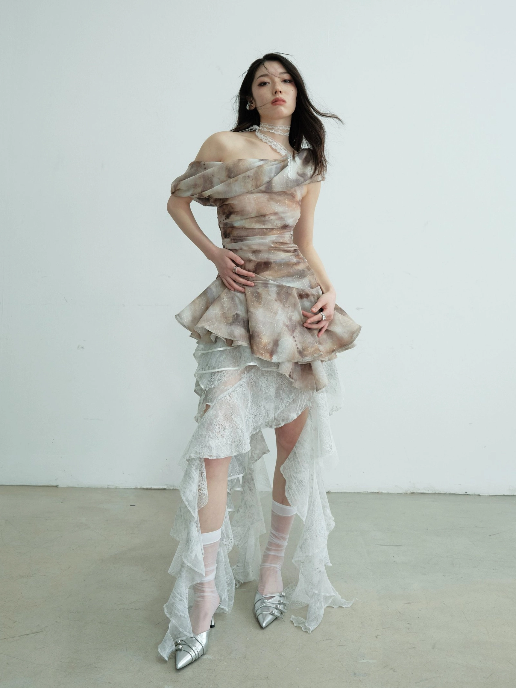 Full body fashion styling view highlighting the fitted silhouette and floor-length layered ruffle hem of a lace tube top maxi skirt