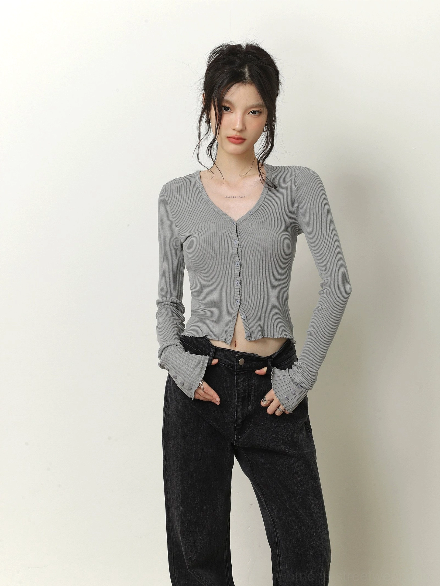 Light gray cropped V-neck ribbed knit cardigan with front buttons styled with black high-waisted jeans