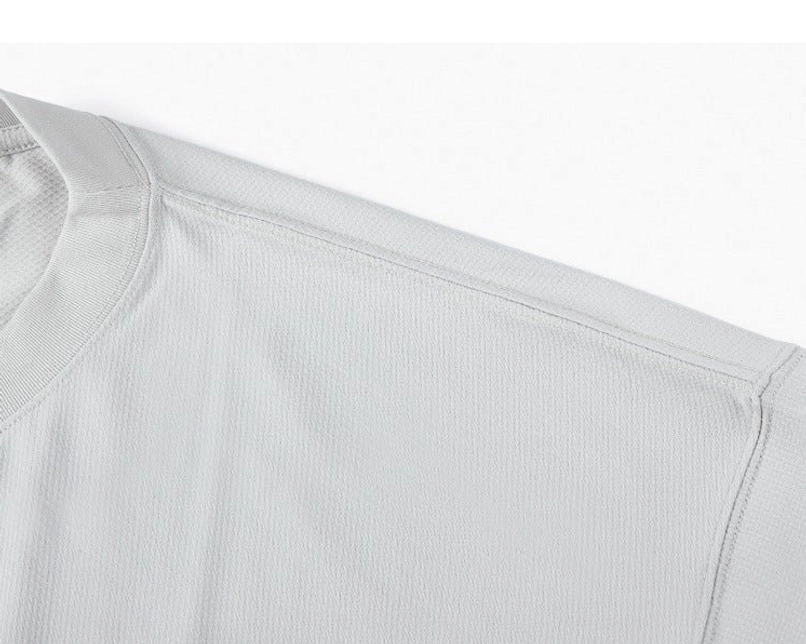 Close-up upper body detail showing neat stitching and soft drape on light gray sweater tee