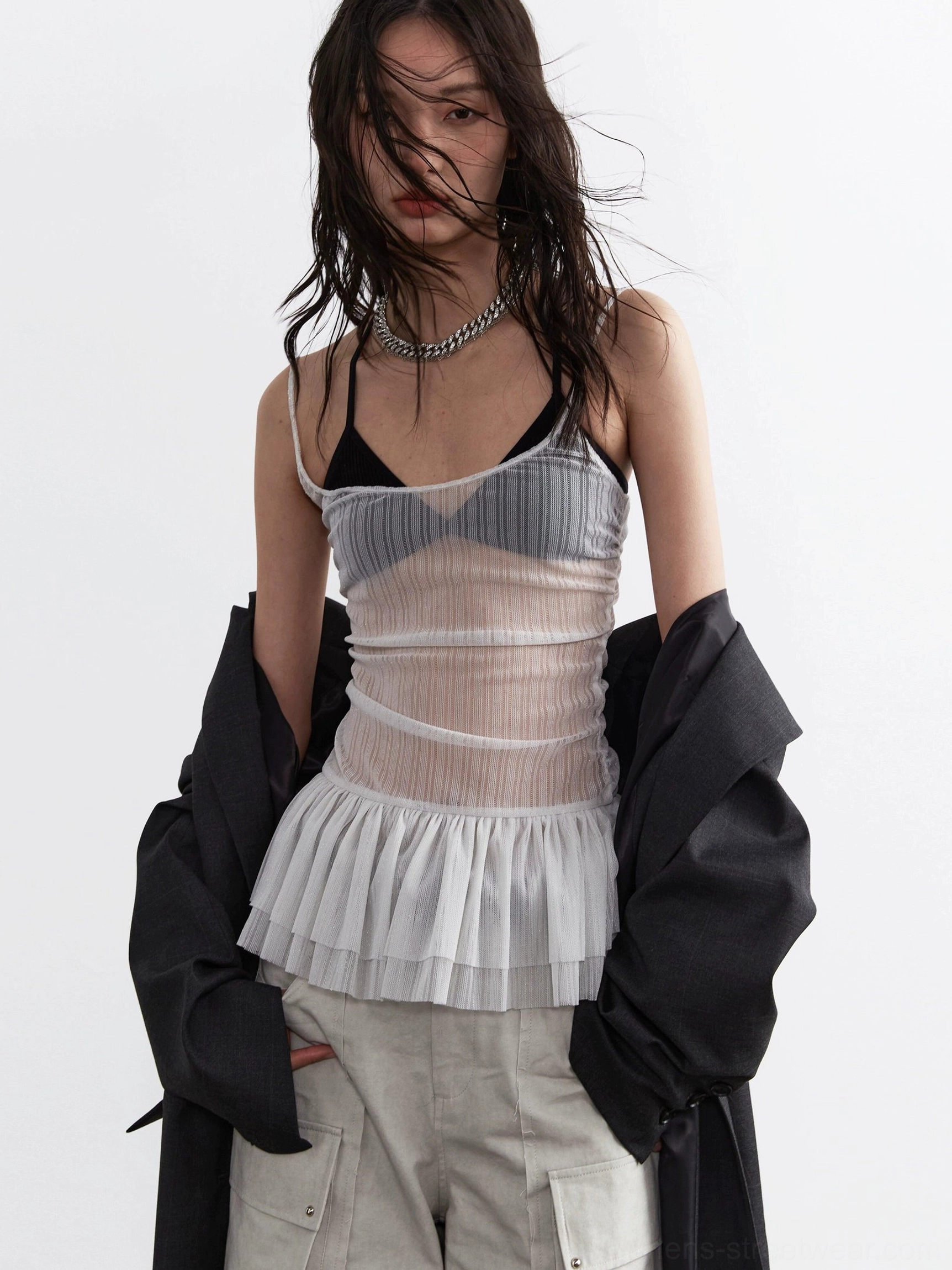 Light gray sheer pleated corset top with tulle peplum styled with black blazer and gray cargo shorts front view