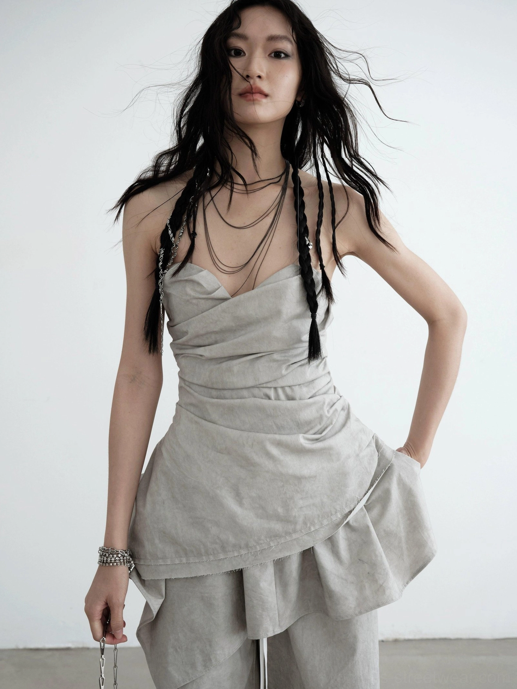 Light gray strapless ruched asymmetric draped top front close-up with sweetheart neckline and layered ruffle hem