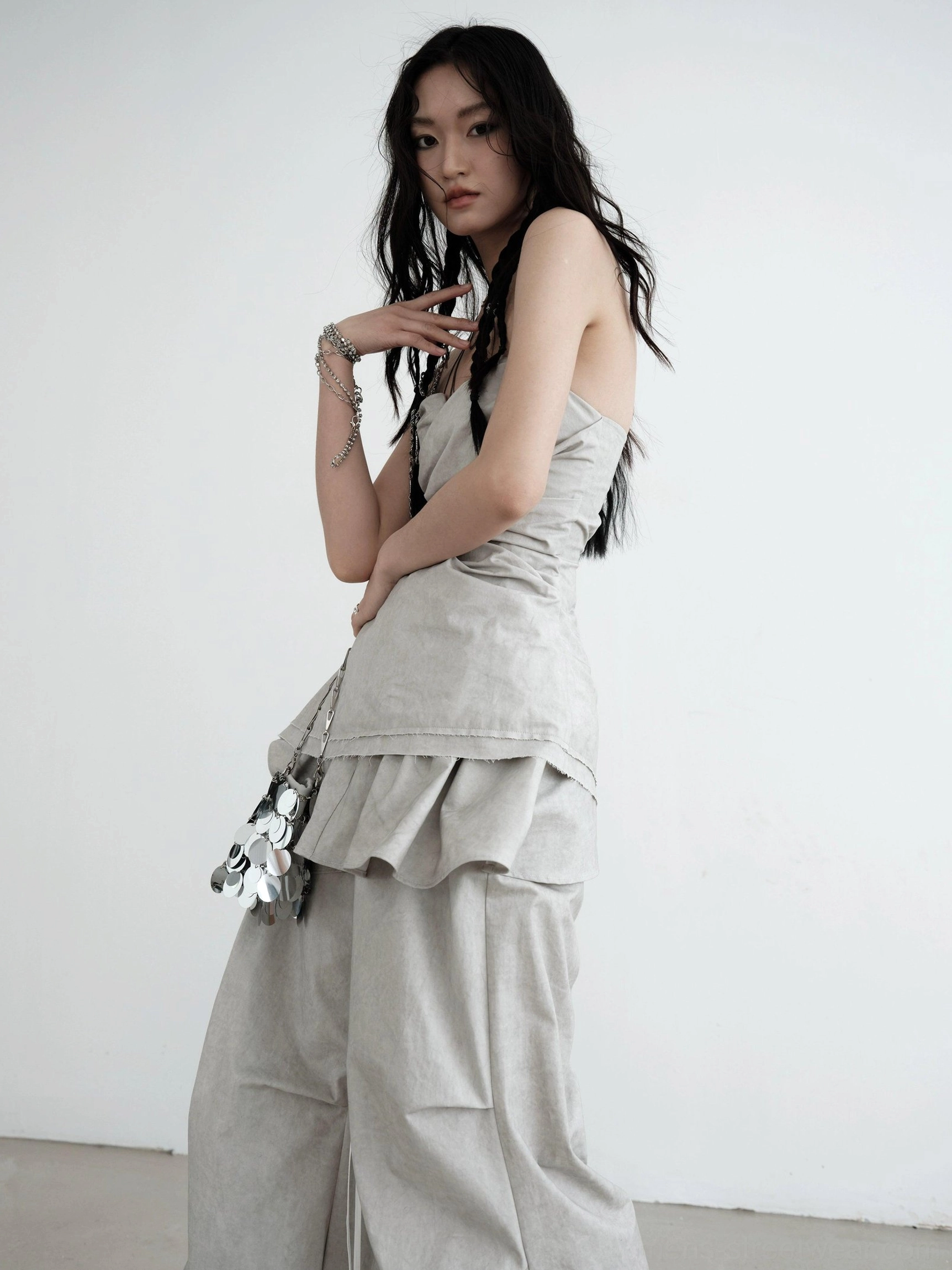 Light gray strapless ruched asymmetric draped top with fitted bodice and layered ruffle hem product view