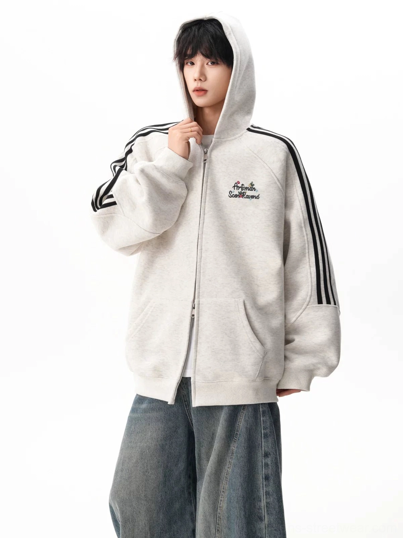Light gray triple stripe hooded sweatshirt worn with the hood up, featuring black sleeve stripes, chest embroidery, and oversized Korean street style