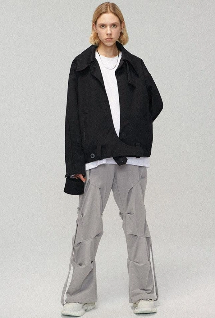 Full-body view of light gray wide-leg streetwear cargo pants styled with a cropped black blazer white tee and white sneakers