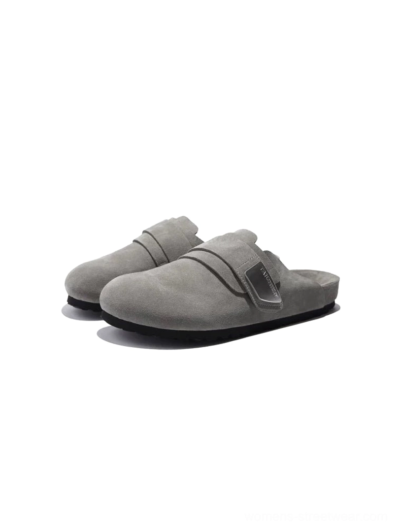 Light grey closed-toe suede mule sandals with round toe silver buckle strap and low black rubber sole