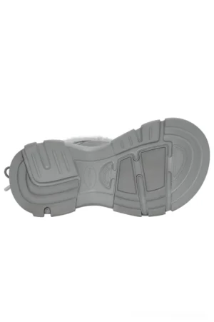 Light grey chunky lug outsole detail for winter snow boots showing the heavy-duty tread pattern and textured platform construction