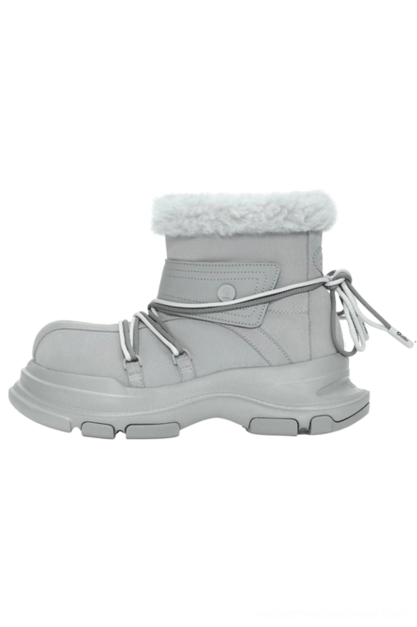 Light grey winter snow boot in side profile with white faux fur cuff, dual-tone drawstrings, hook-and-loop ankle strap, and chunky lug platform sole