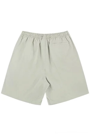 Light khaki relaxed cotton beach shorts shown from the back with elastic waistband and functional rear patch pocket