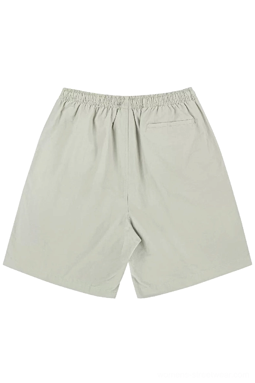 Light khaki relaxed cotton beach shorts shown from the back with elastic waistband and functional rear patch pocket