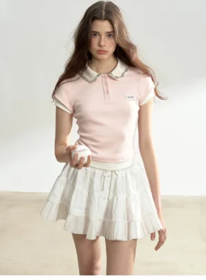 Light pink fitted lace collar cotton polo shirt with half button placket and white pleated mini skirt