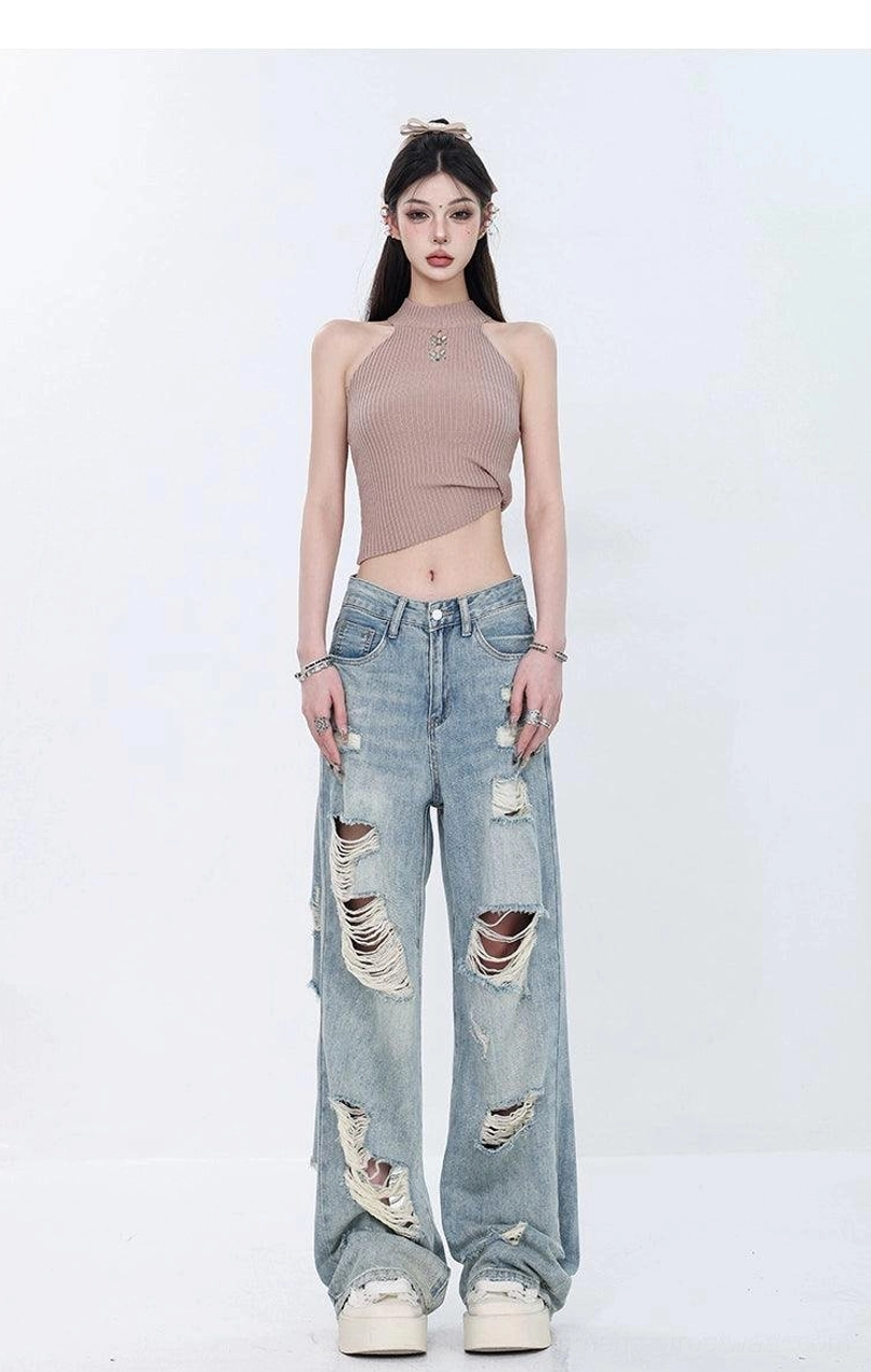 Full front view of light wash ripped wide-leg grunge jeans with a clean high waist and distressed denim legs