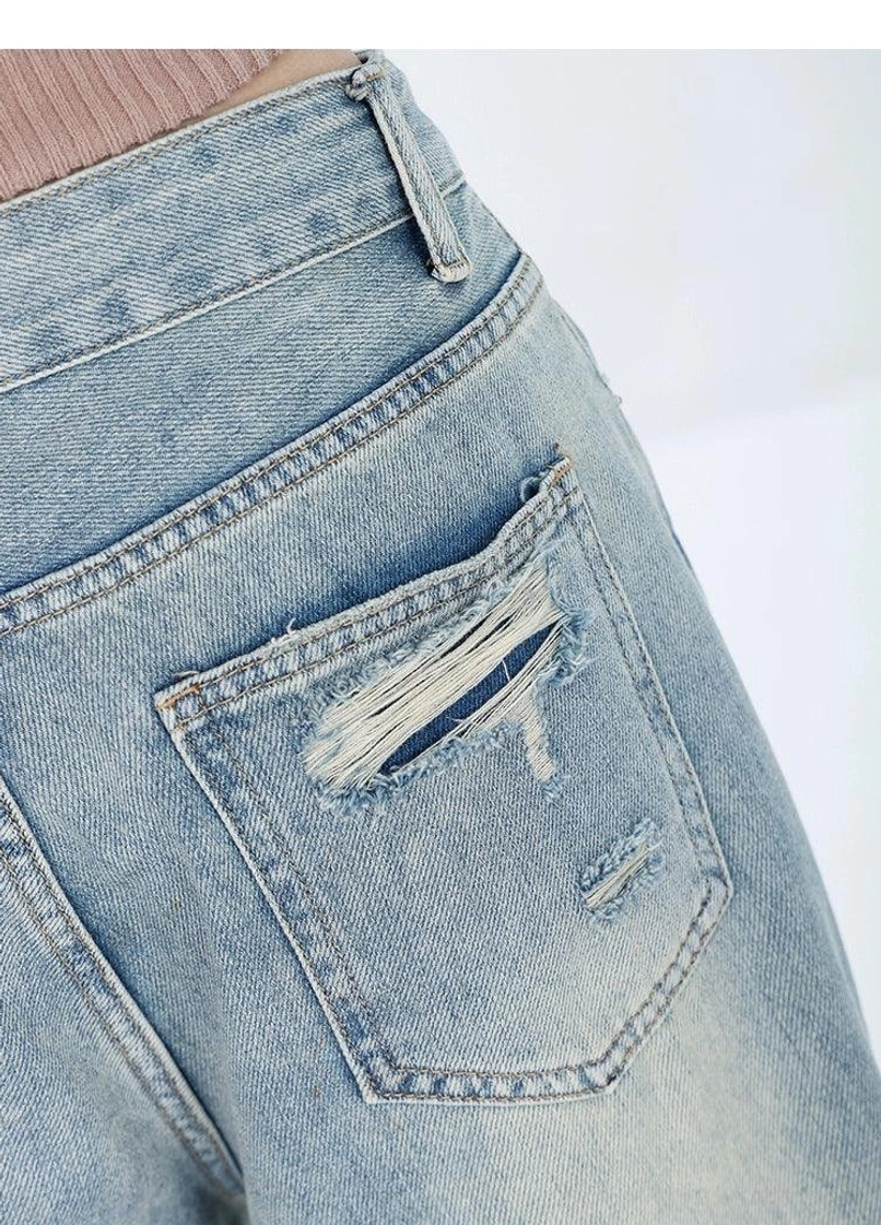 Light wash distressed high-waist wide-leg grunge jeans relaxed fit denim construction and wide hem detail