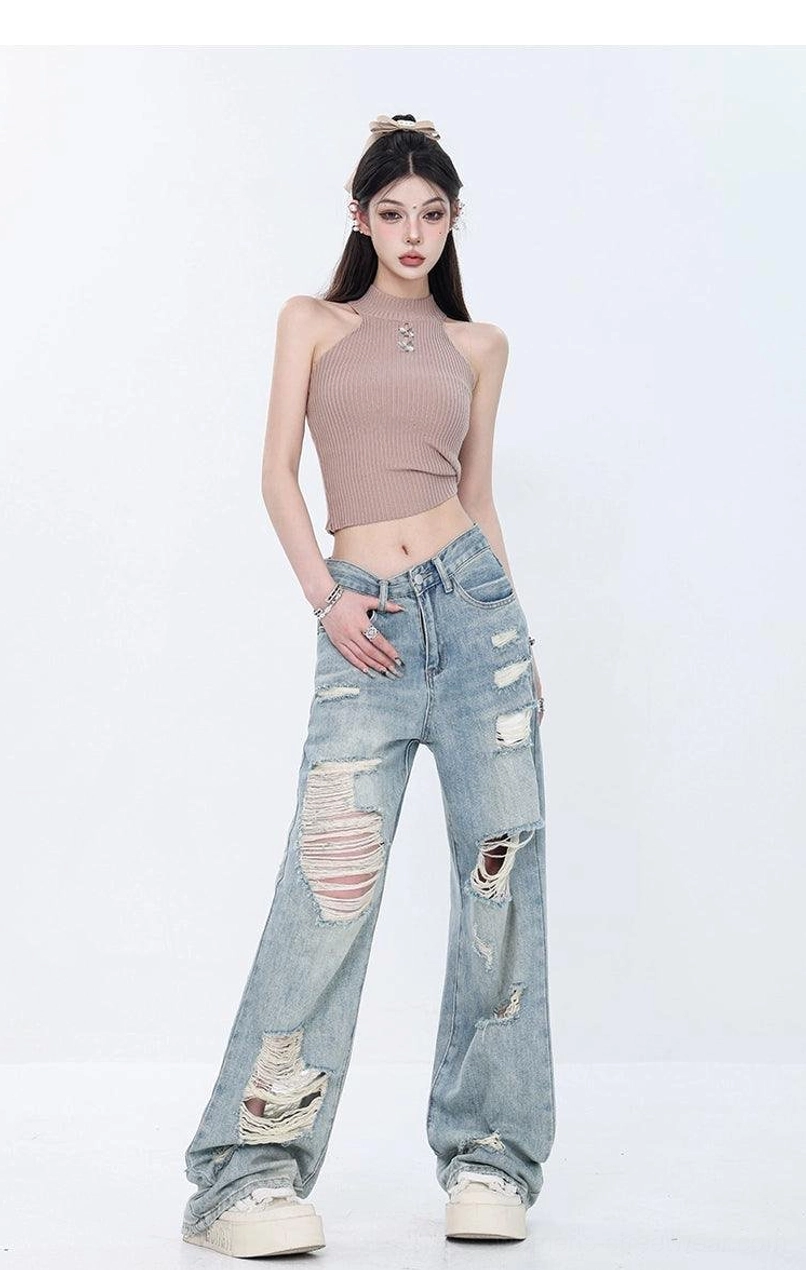 Streetwear outfit featuring light wash distressed high-waist wide-leg grunge jeans with loose legs and vintage faded denim