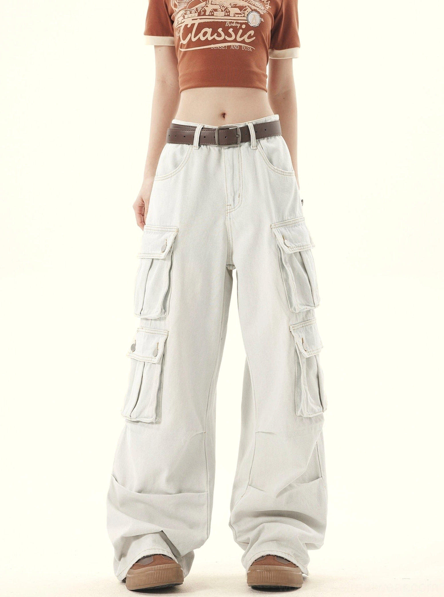 Front full body view of women wearing light wash gray wide leg denim cargo pants with thigh flap pockets