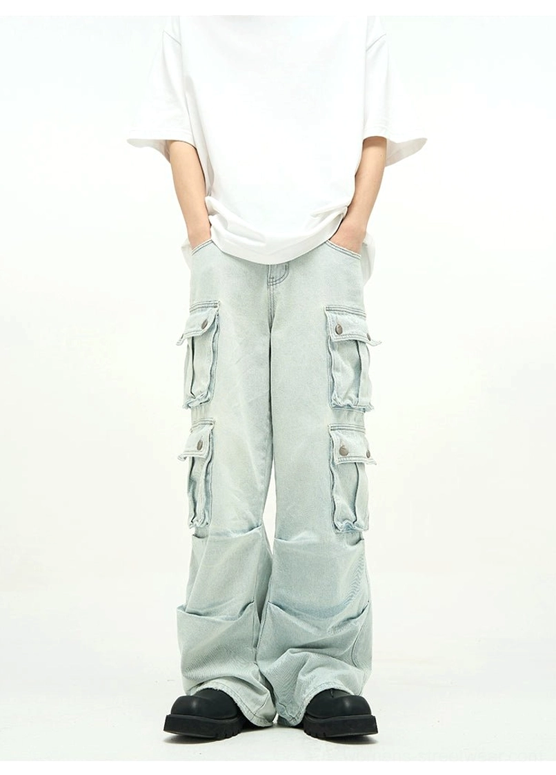 Light wash oversized cargo jeans with neat symmetrical flap pockets, high-rise waist, relaxed thighs, and wide-leg contemporary denim cut