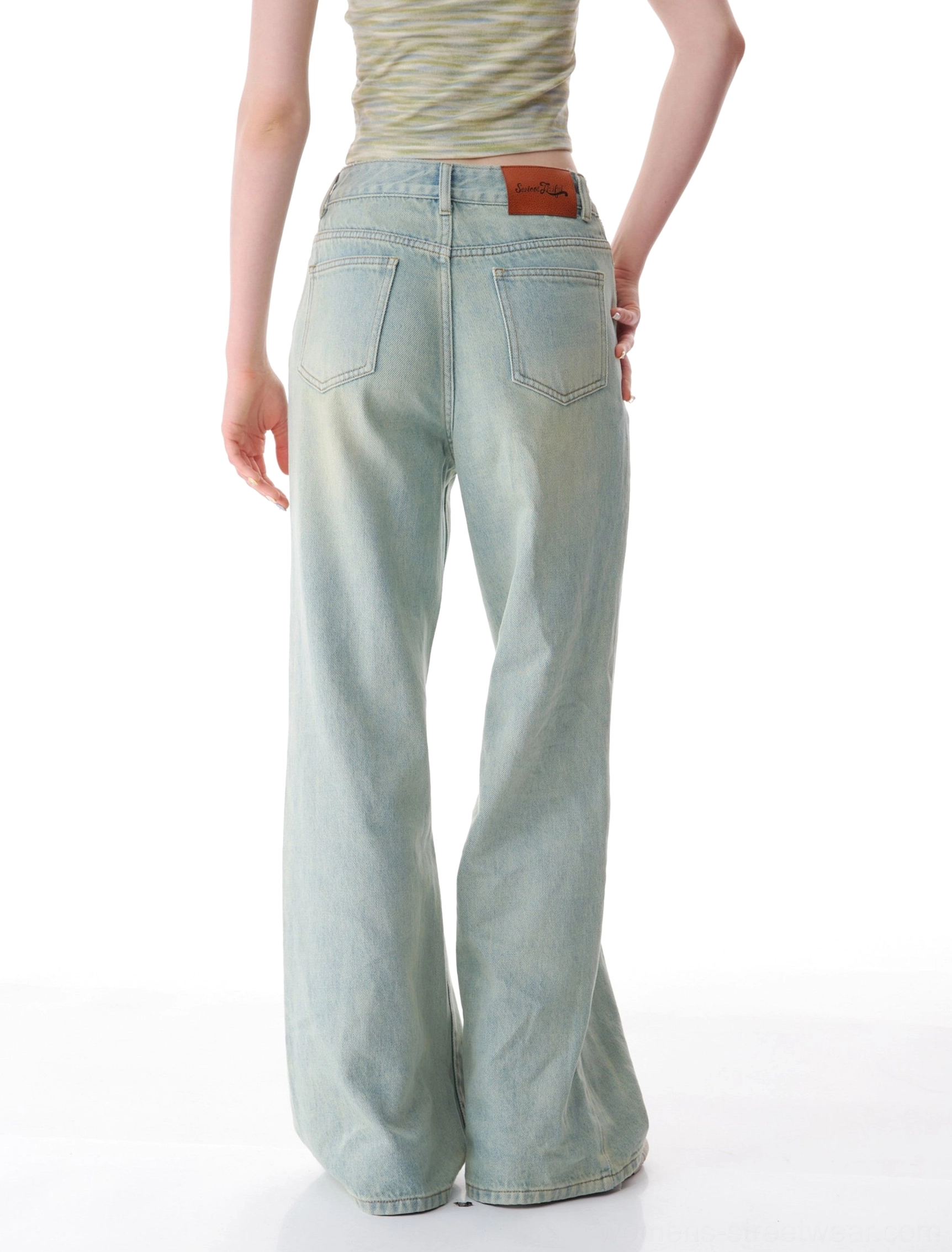 Back view of faded light wash wide leg jeans showing classic back pockets and rear waistband patch