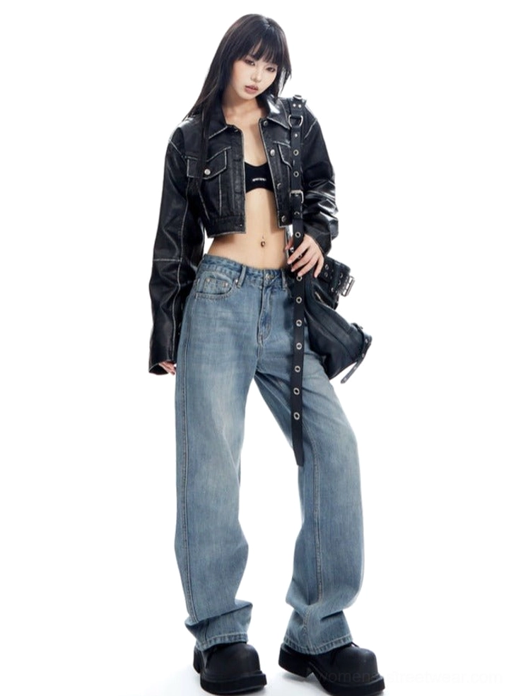 Modern streetwear outfit featuring light wash wide-leg jeans, a cropped black jacket, chunky shoes, and a black biker handbag