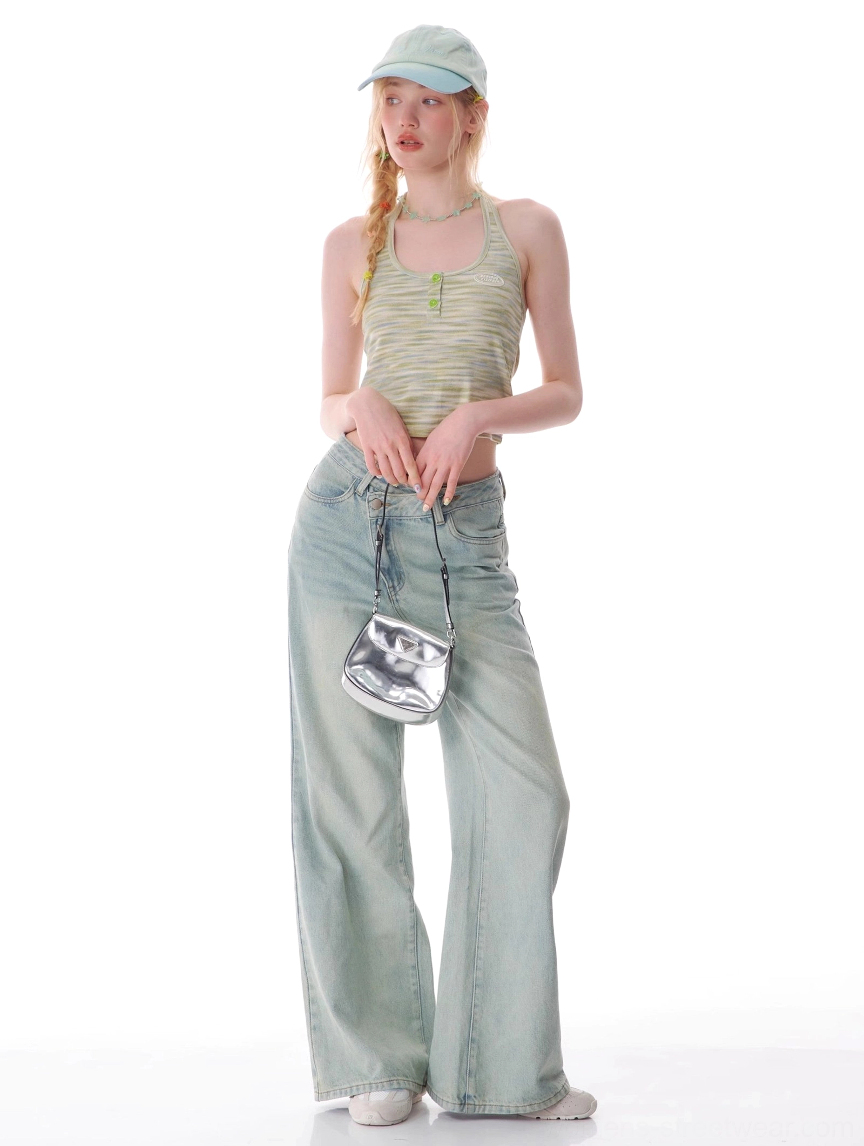 Full outfit featuring light wash wide leg jeans, striped halter top, baseball cap, and silver mini handbag