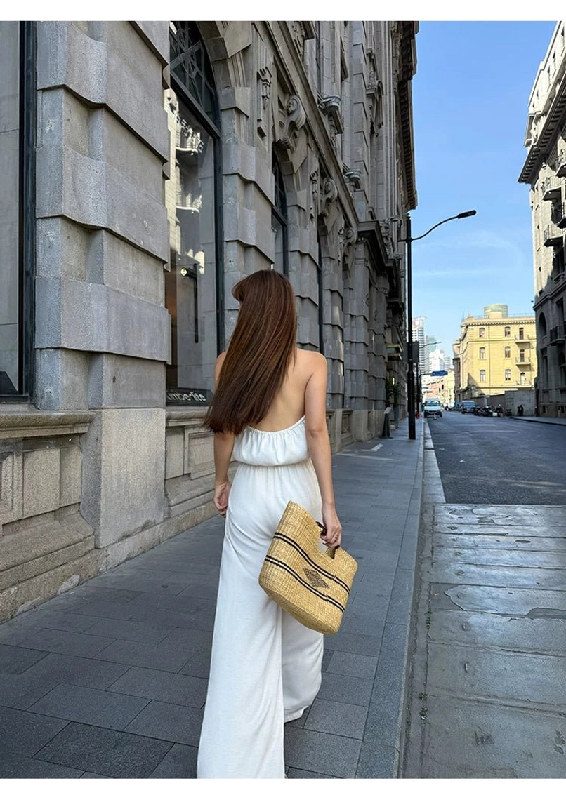 Lightweight draped halter jumpsuit with wide-leg pants, breathable rayon blend, and elegant wrap-front bodice