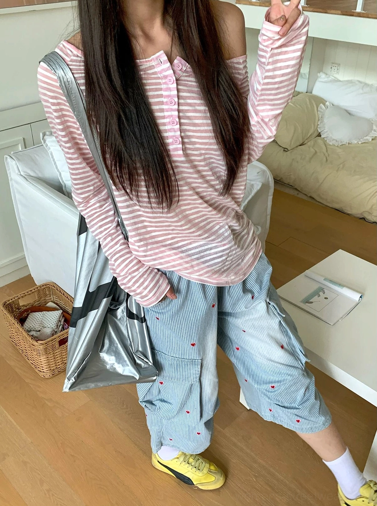 Side view of lightweight off-shoulder striped henley long sleeve tee with loose draped silhouette