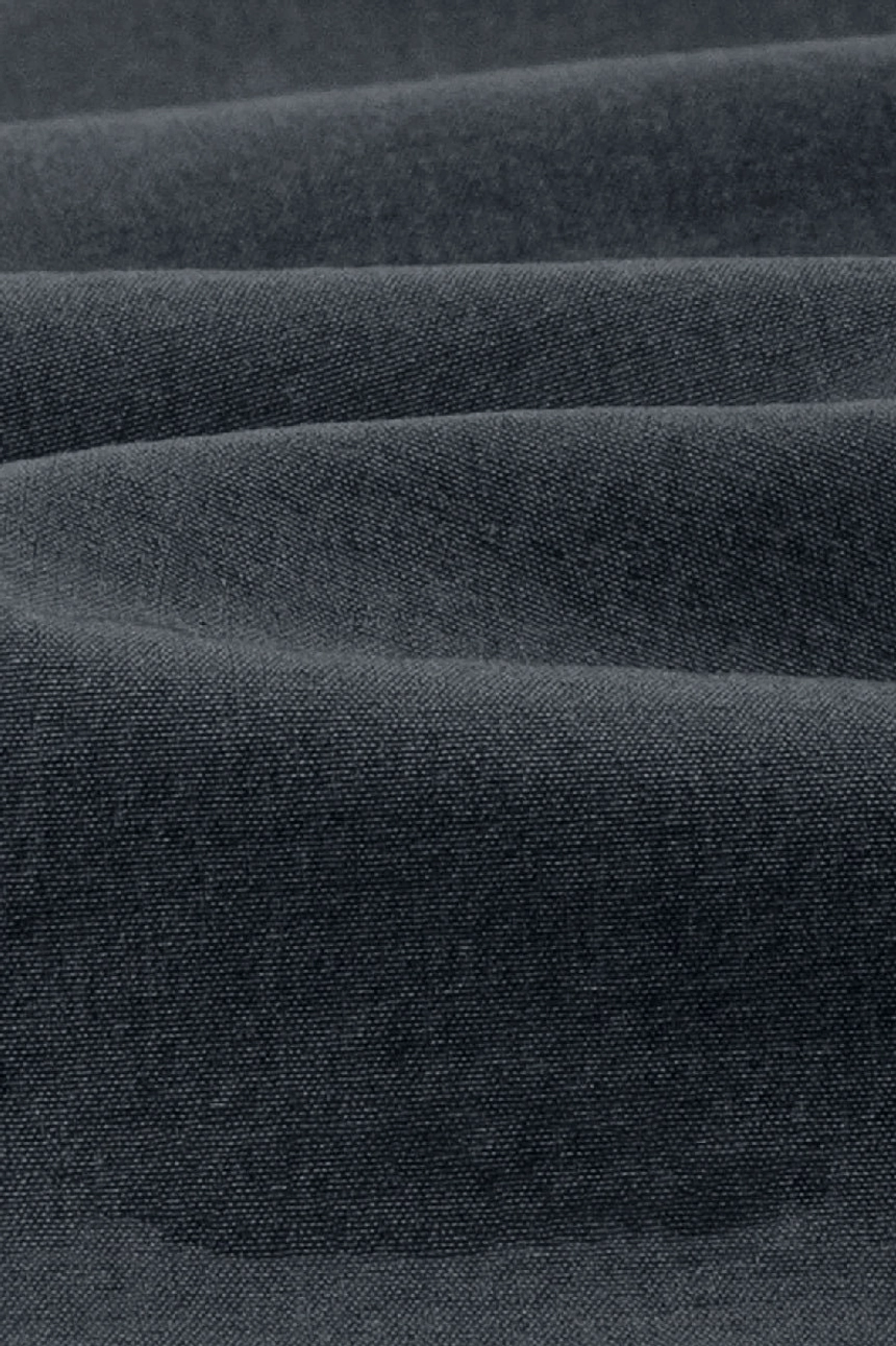 Close-up view of dense matte woven cotton fabric from lightweight tech shorts showing smooth texture durable construction and wrinkle-resistant finish