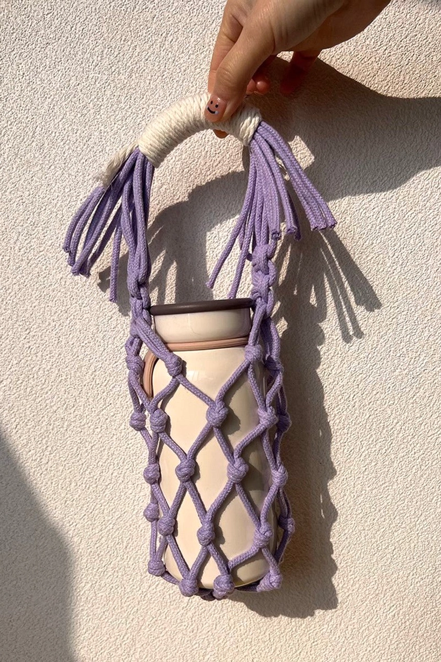 Lilac cotton macrame water bottle carrier accessory with textured hand-knotted rope construction for casual streetwear styling