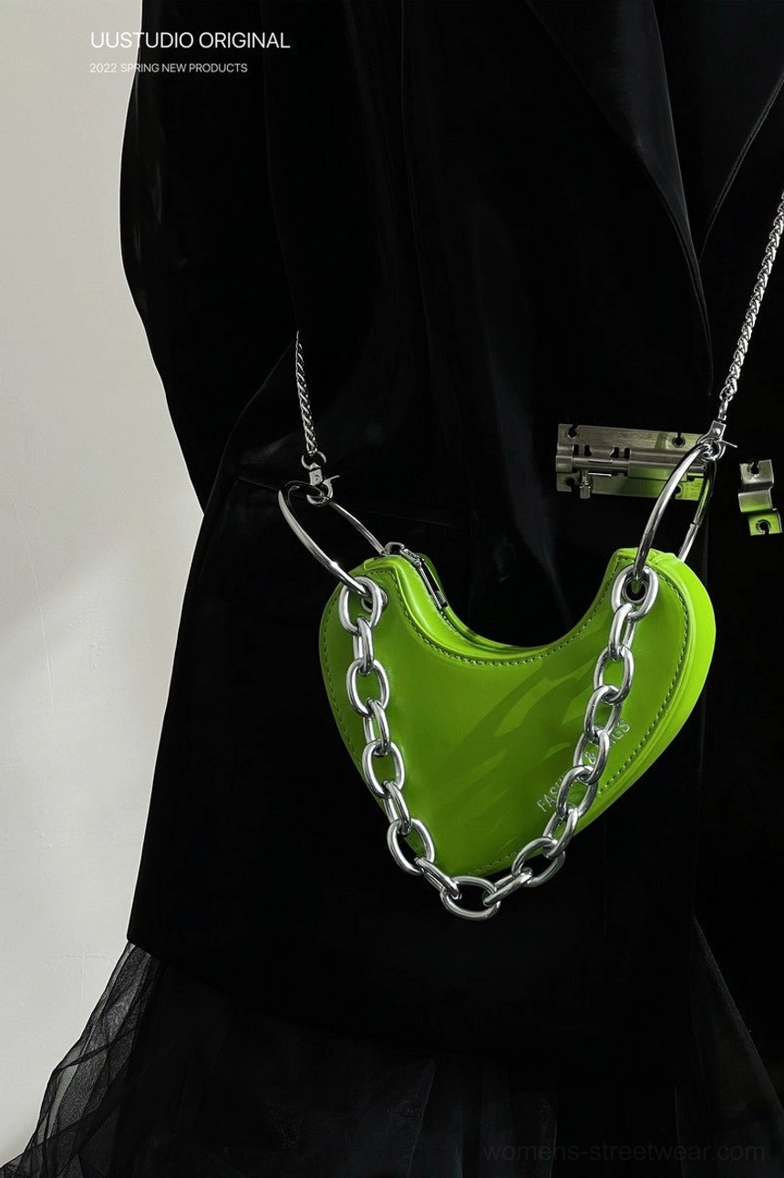 Lime green heart chain mini bag worn crossbody with black blazer and tulle skirt