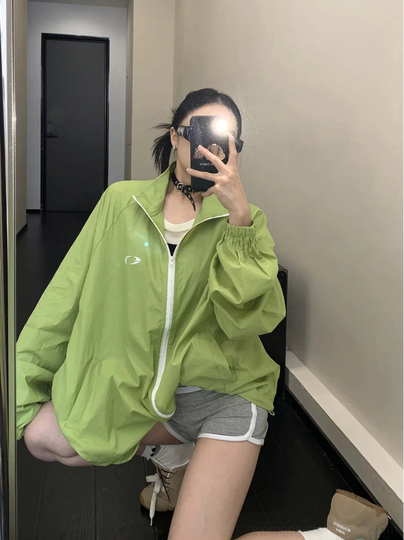 Front mirror view of a lime green oversized UPF50+ windbreaker jacket with white zipper, small chest logo, elastic cuffs, and relaxed Acubi streetwear fit