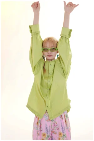 Model wearing a lime green ruffled cotton blouse with loose lantern sleeves and lace trim in a colorful Korean streetwear outfit