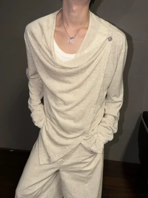 Linen beige asymmetric draped button long-sleeve streetwear top shown on a model with a gathered cowl neckline and layered styling