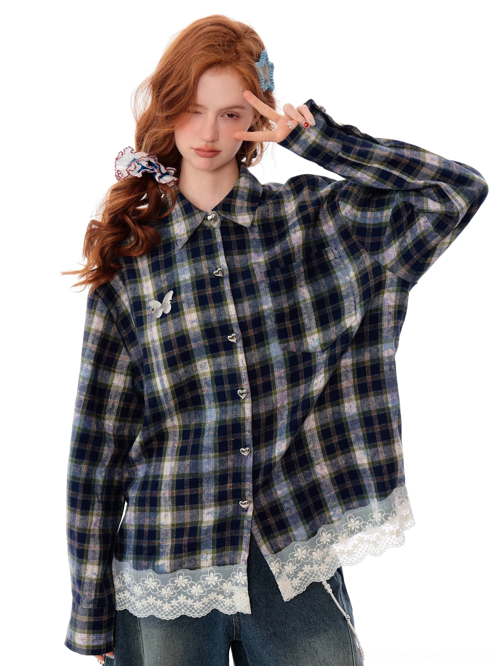 Three-quarter front view of a loose blue plaid lace trim shirt with matching ribbon tie and butterfly brooch detail