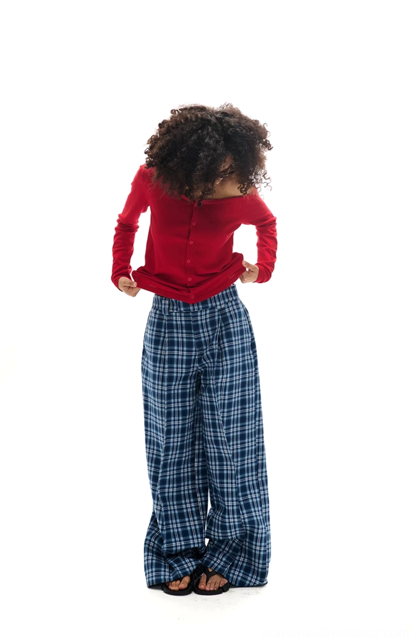 Back and front view of loose blue plaid wide-leg trousers styled with a red off-shoulder top and casual sandals