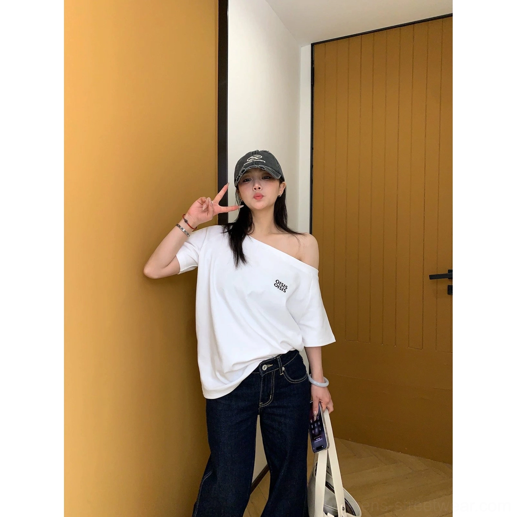 Loose-fit off-shoulder logo T-shirt with short sleeves, soft cotton jersey fabric, and modern Seoul streetwear styling