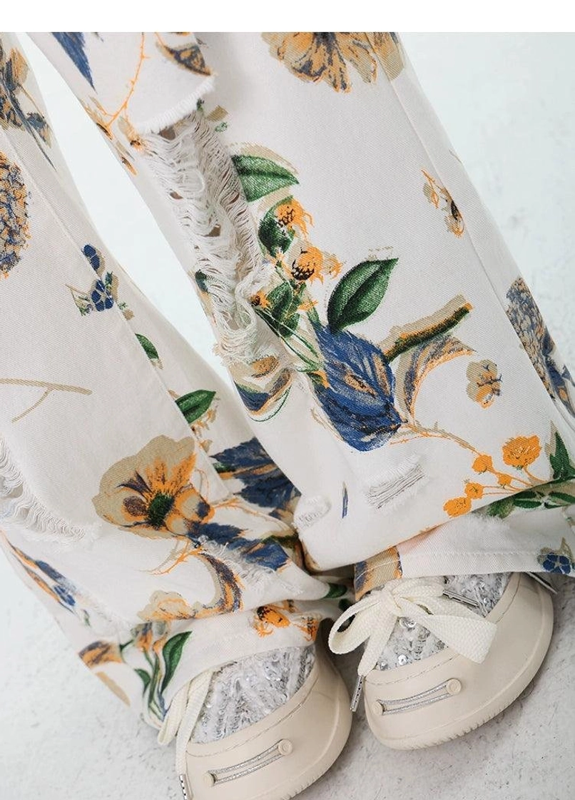 Loose women's floral print jeans with wide-leg silhouette and rugged distressed denim finish