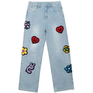 Light wash embroidered straight-leg jeans with colorful heart flower smiley face and snake appliques in a front studio view