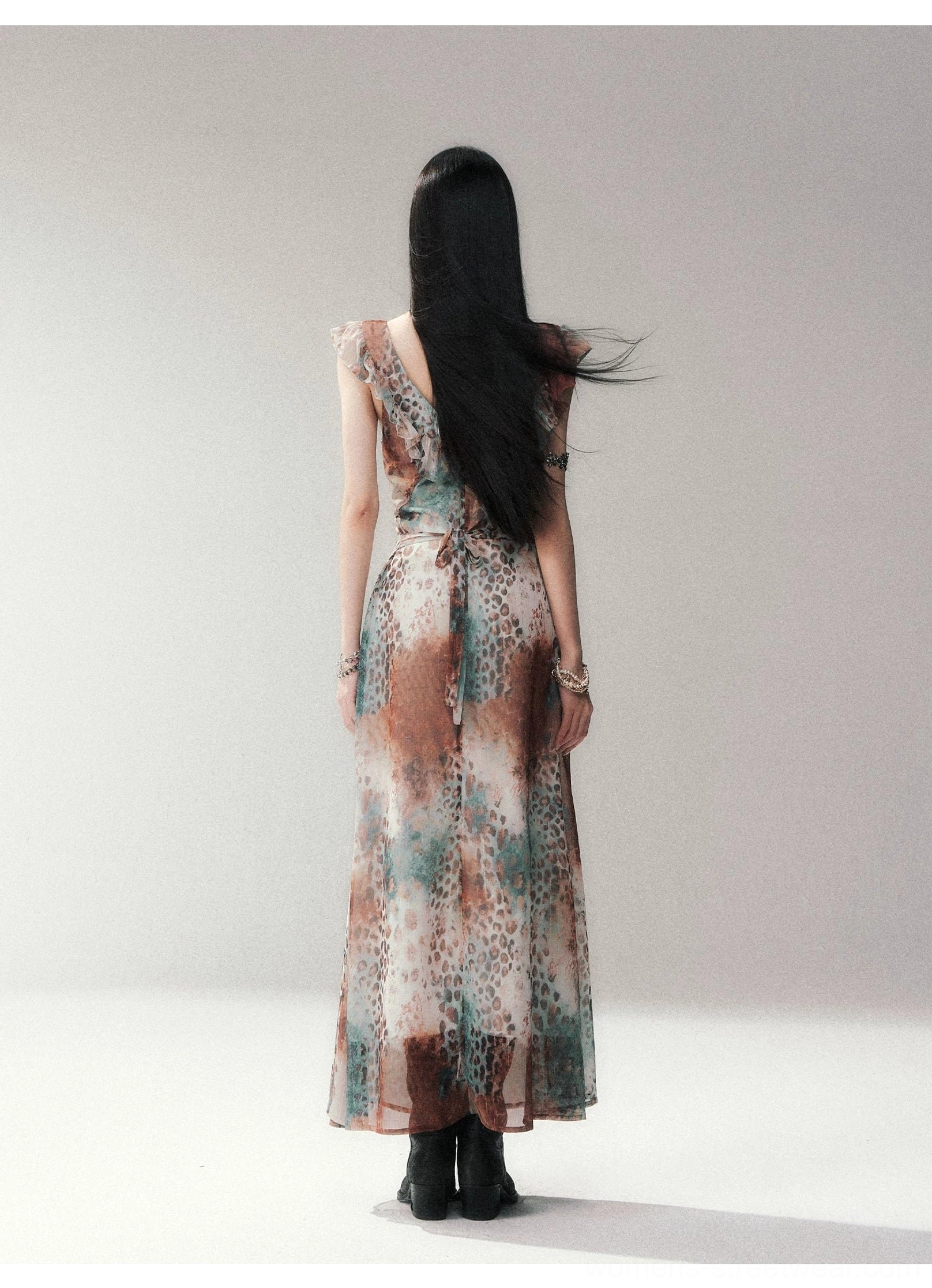 Full back view of a lightweight watercolor leopard maxi dress with low open back, ruffled shoulder straps, tied waist, and flowing skirt