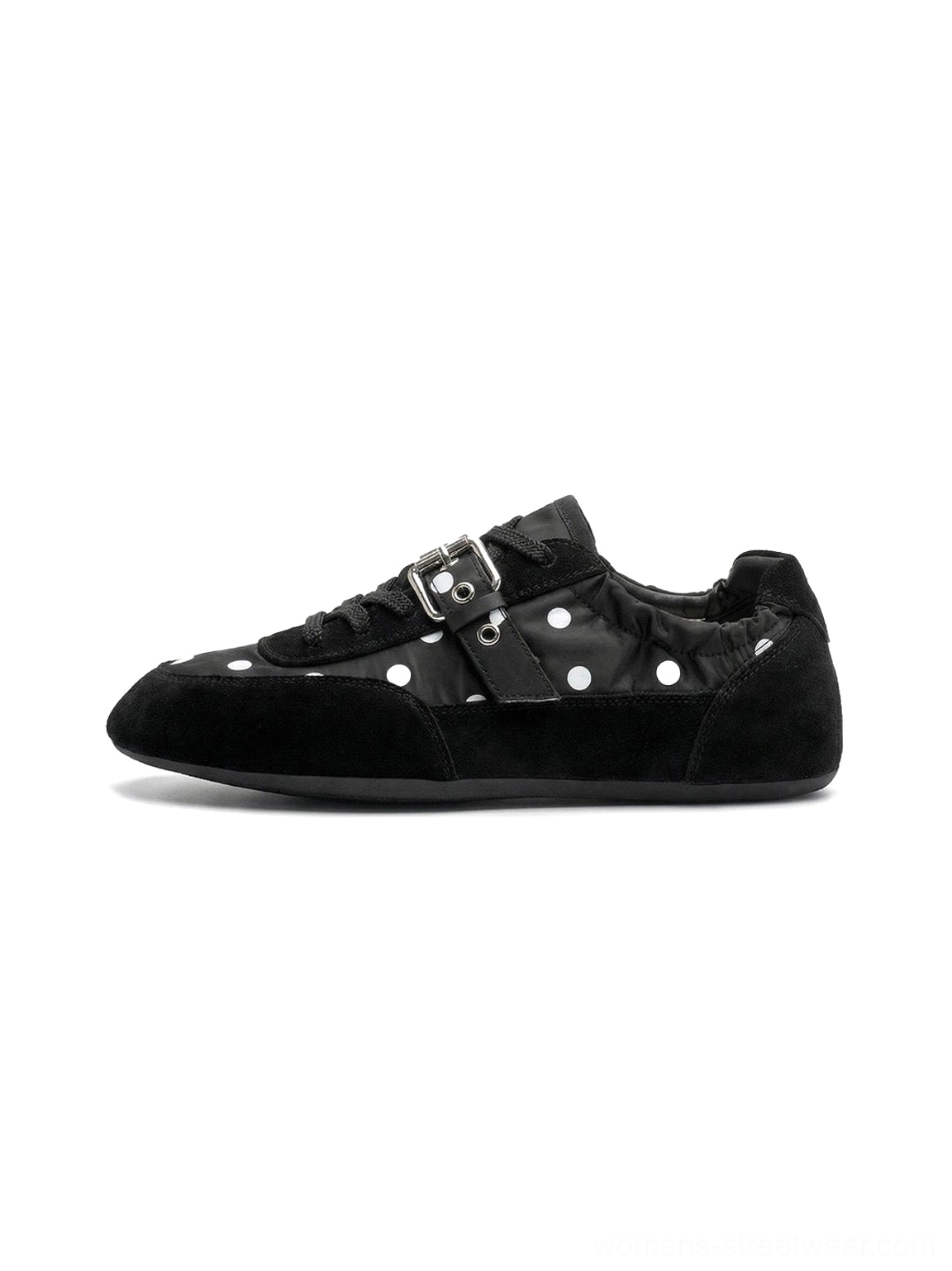 Black low-profile polka dot ballet sneakers with white dots, silver buckle strap, suede-look toe cap, and flat streetwear sole