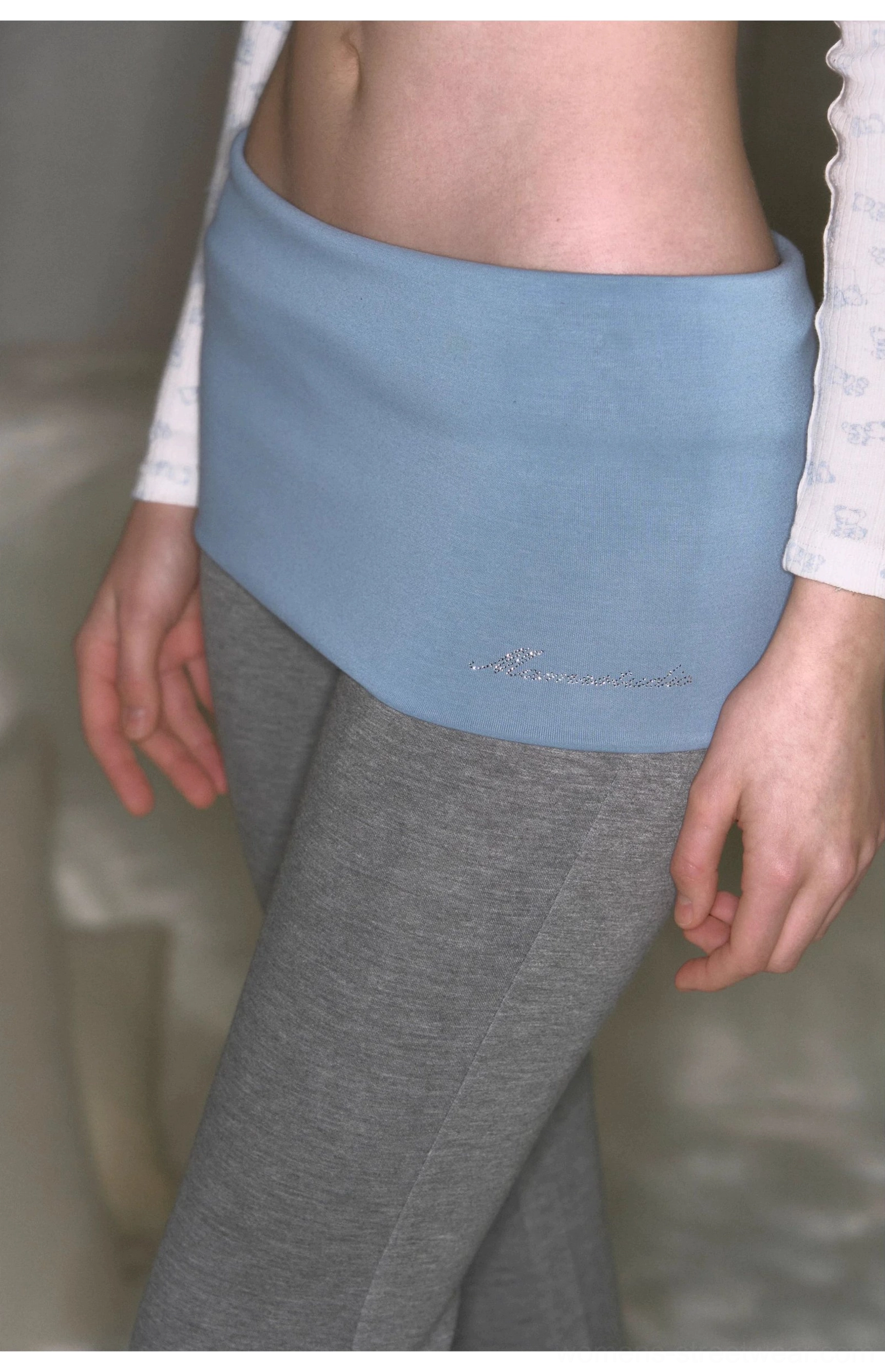 Low-rise slim fit micro flare yoga pants featuring contrast fold-over waistband and soft stretch knit fabric