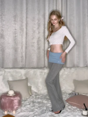 Gray low-rise colorblock fold-over micro flare yoga pants shown in a three-quarter front full-body streetwear outfit view