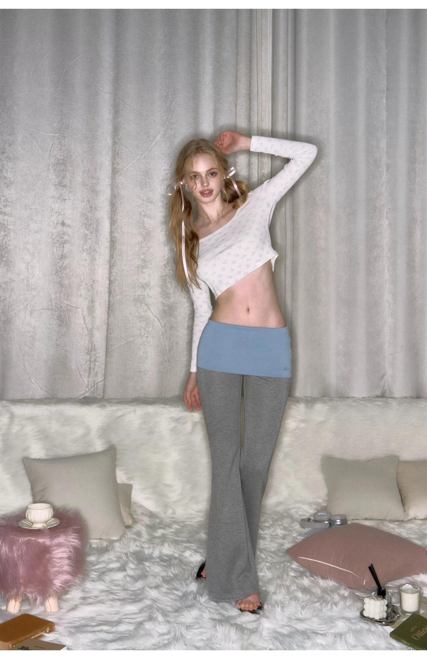Three-quarter side view of gray low-rise micro flare yoga pants with sculpting fitted legs and subtle flare hem