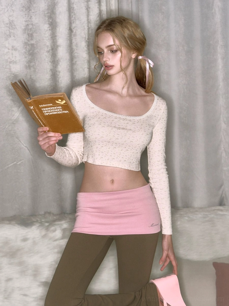 Khaki low-rise micro flare yoga pants with pink fold-over waistband shown in a front full-body Y2K streetwear look