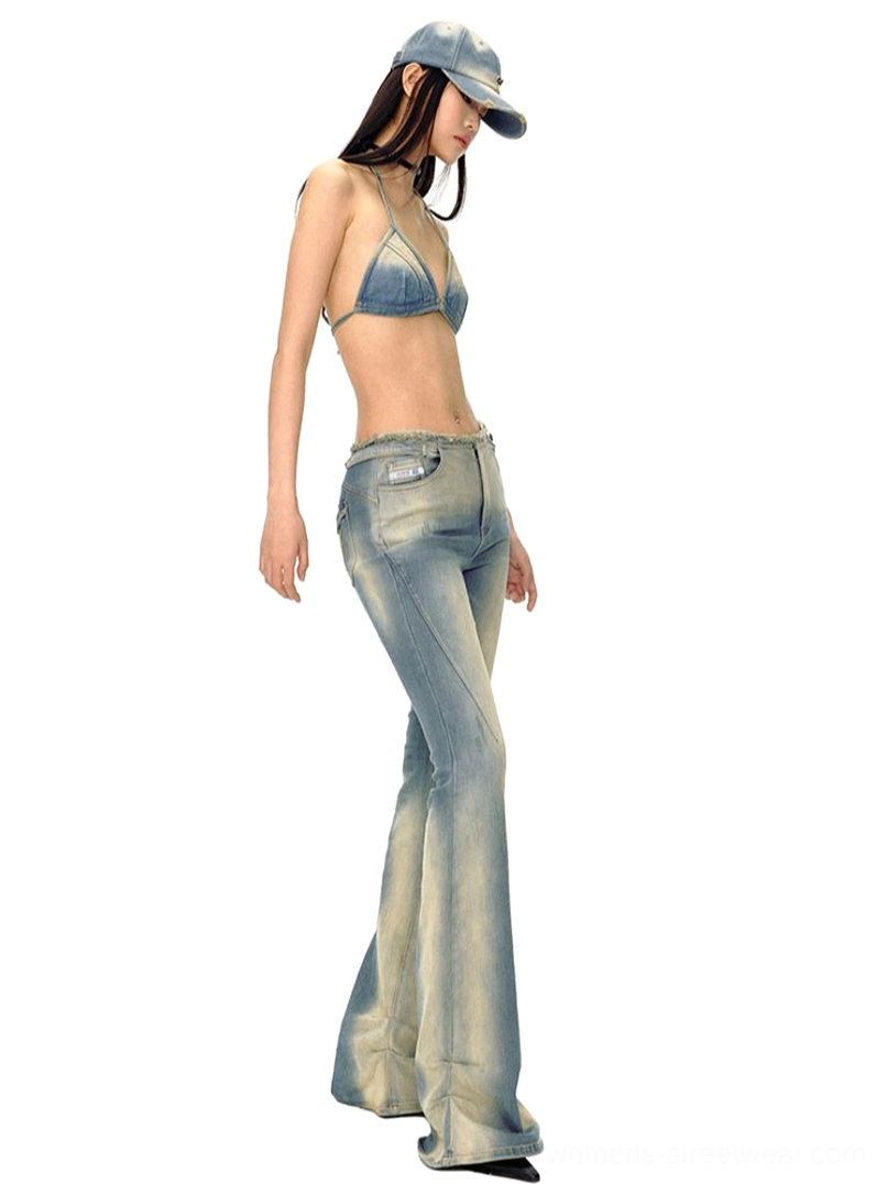 Low-rise vintage blue flared denim jeans shown in a side view with slim fit and dramatic full-length legs