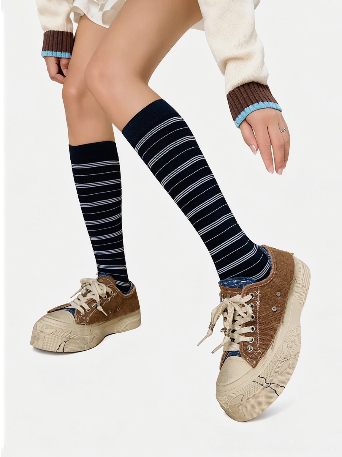 Low-top brown and blue distressed platform sneakers with dark lining styled with cropped knitwear