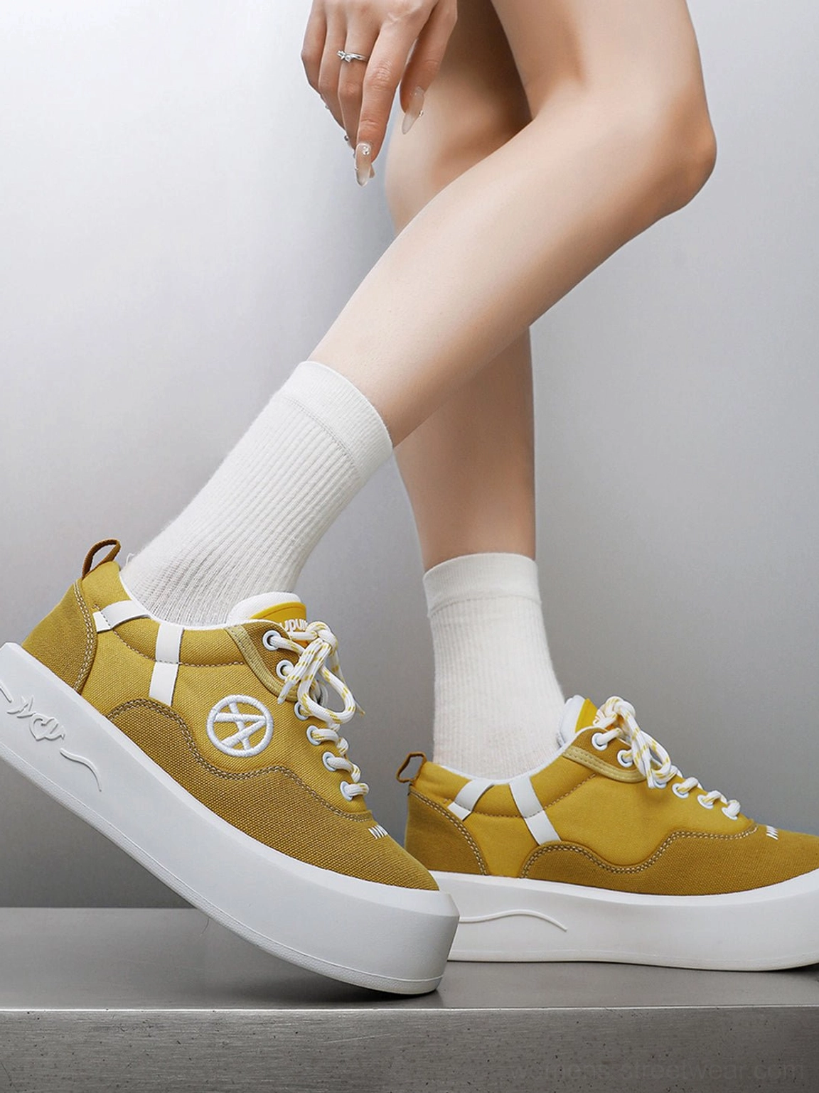Low-top neon canvas sneakers with bold color blocking and thick white platform sole for modern streetwear looks